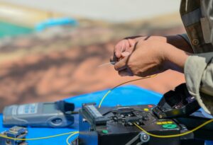Technicians are cutting and fusion fiber optic cables.